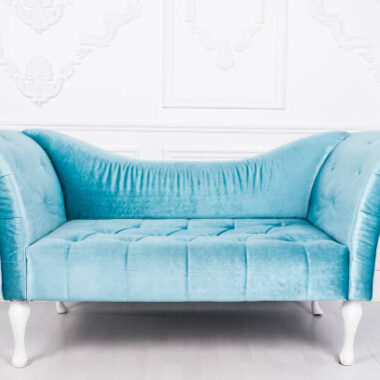 Blue sofa in white interior and gray floor. venetian style