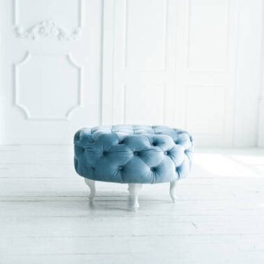 Round blue stool in white studio